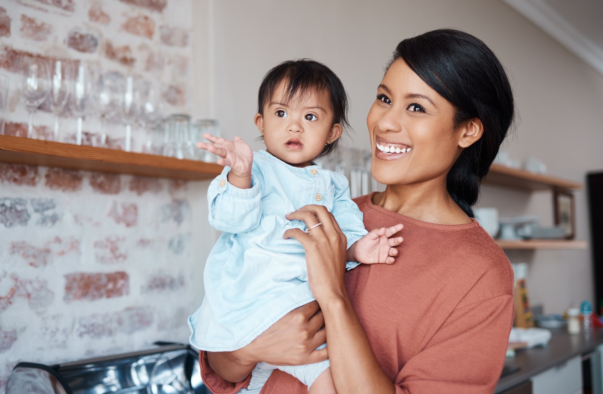 Disability, mother and baby with down syndrome in a happy and lovely family home with childcare on